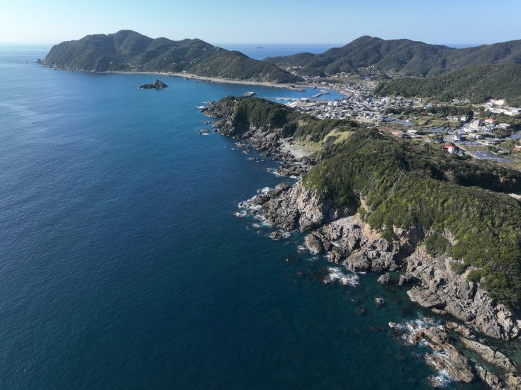 A body of water with hills and land